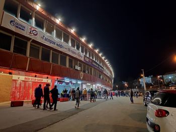 People on illuminated city street at night