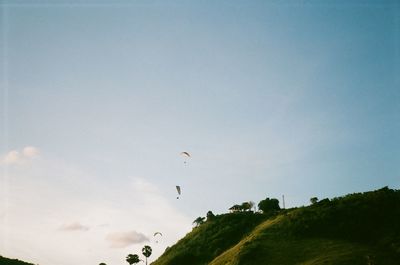 Low angle view of airplane flying against sky