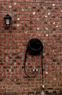 Electric lamp on brick wall