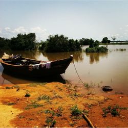 Boats moored in lake against clear sky