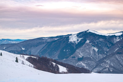 Scenic view of snowcapped mountains against sky during winter