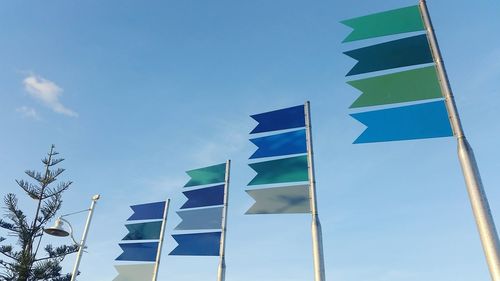 Low angle view of flag against blue sky