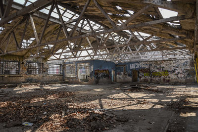 Abandoned building seen through broken glass window