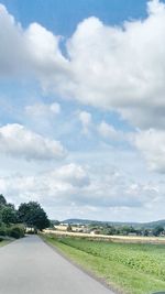 Road by landscape against sky