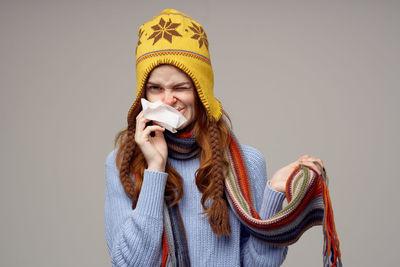 Portrait of woman wearing hat against white background