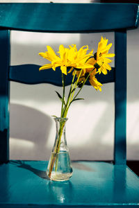 Close-up of yellow flowers in vase on table