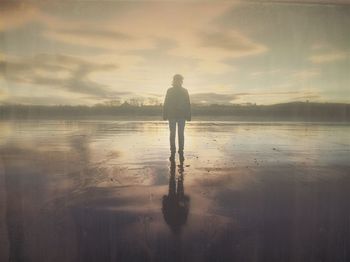 Silhouette of woman standing on beach