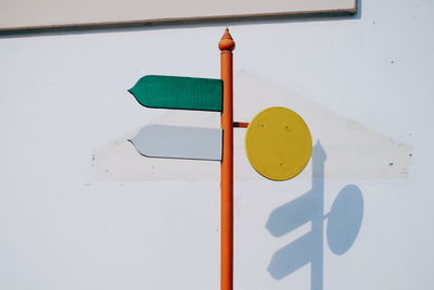 Close-up of arrow sign on wall