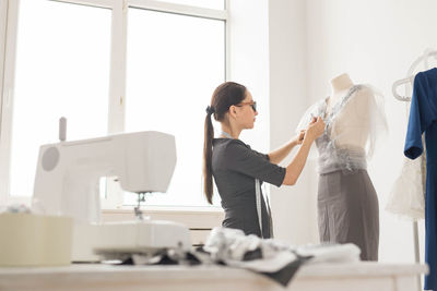 Side view of woman working on table