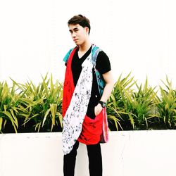 Young woman standing against clear sky