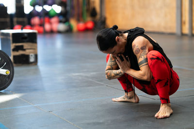 Low section of woman exercising in gym