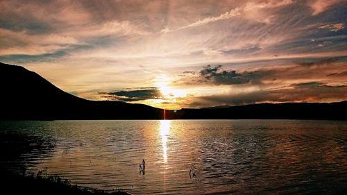 Scenic view of lake against sky during sunset