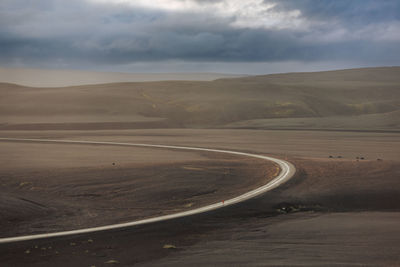 Road carving cross a black sand desert i9n iceland