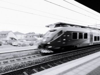 Train at railroad station against sky