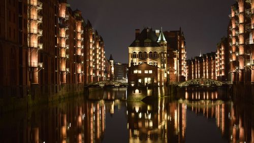 Reflection of illuminated buildings in city at night