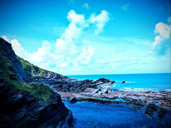 Panoramic view of sea against blue sky