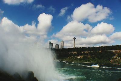 Scenic view of waterfall against sky