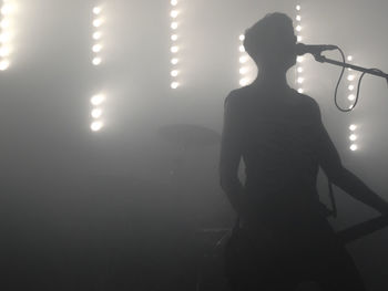 Silhouette musician performing on stage at nightclub