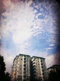 Low angle view of building against cloudy sky