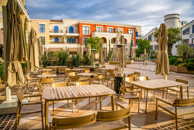 Empty chairs and tables in restaurant