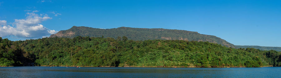 Scenic view of mountains against blue sky