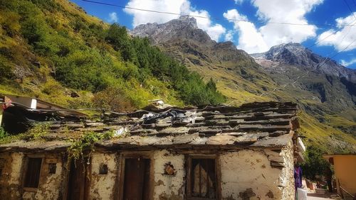 Exterior of old building by mountains against sky