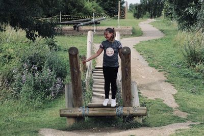 Full length of men standing on wood against trees