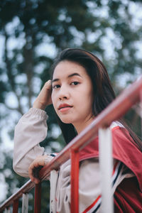 Portrait of young woman looking away outdoors