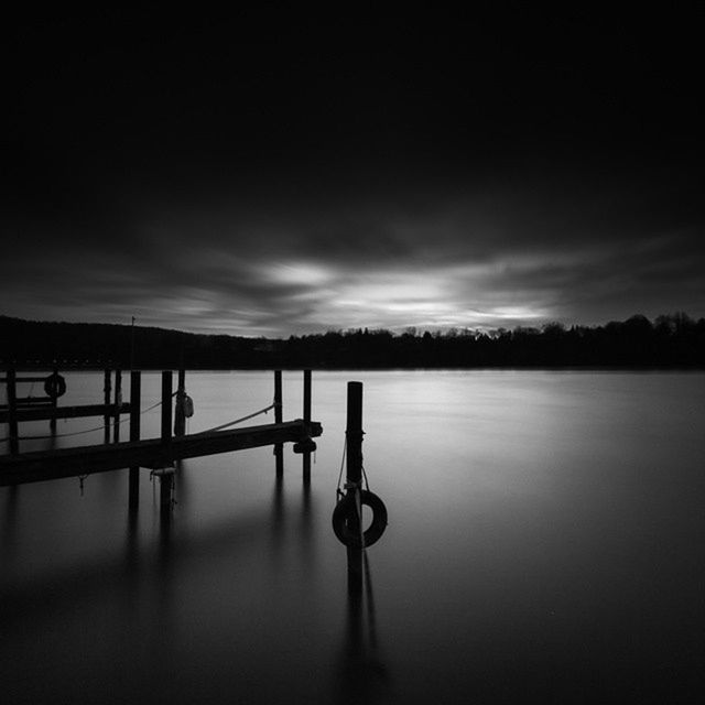 water, sky, tranquility, tranquil scene, silhouette, lake, scenics, beauty in nature, nature, cloud - sky, pier, sunset, dusk, idyllic, cloud, reflection, calm, river, outdoors, railing