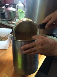 Close-up of hand holding coffee cup