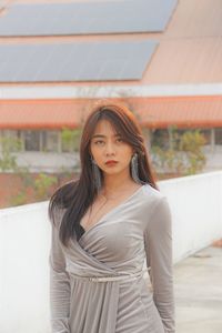 Young woman standing on building terrace