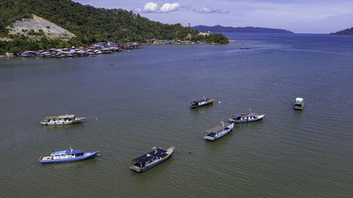 High angle view of boats moored in sea against sky