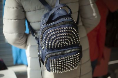 Backpack made of rivets. pack rivets on bag. fashionable backpack on girl.