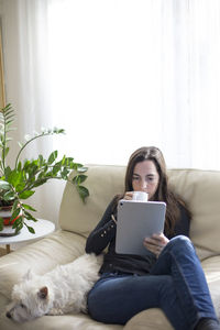 Man sitting on sofa at home