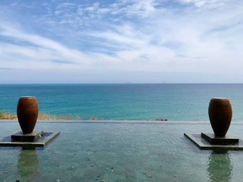 Scenic view of swimming pool by sea against sky