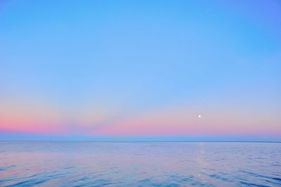 Scenic view of sea against clear sky at sunset