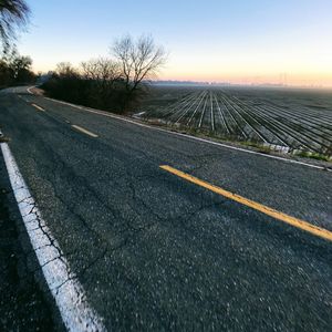 Road against clear sky at sunset