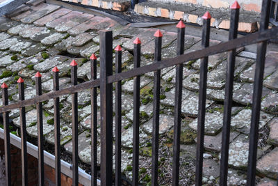 High angle view of railing by fence