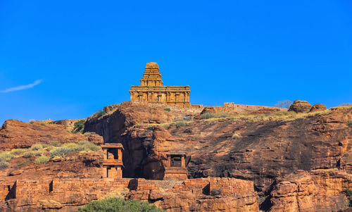 Low angle view of old ruins against clear blue sky