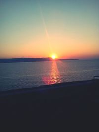 Scenic view of sea against clear sky during sunset