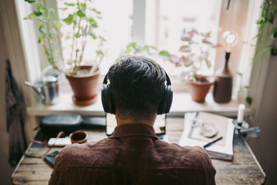 Rear view of businessman working at home during pandemic