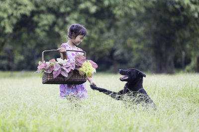 Woman with dog on field