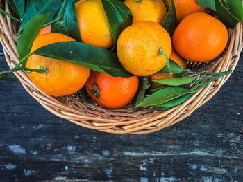 Directly above shot of oranges with basket on table