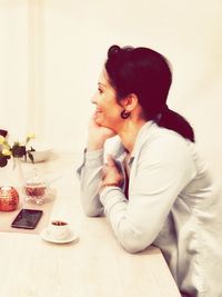 Young woman eating food on table