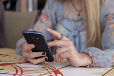 Midsection of woman using mobile phone