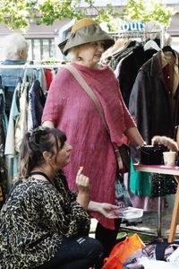 Rear view of people standing at market
