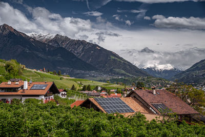 Scenic view of mountains and houses against sky