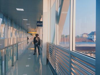 Man standing in corridor of building