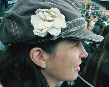 Close-up of woman wearing cap in stadium