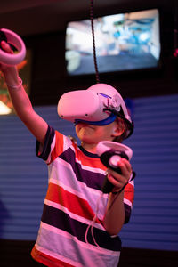 Vr game and virtual reality. kid boy gamer six years old fun playing on futuristic video game